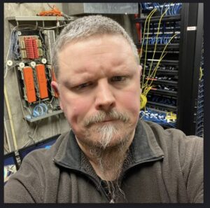 Matthew Haga, City of Crystal Systems Administrator in front of their new Mitel on-premise phone system